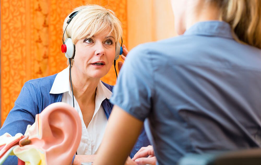 A female getting her hearing assessment done at Audiological Services