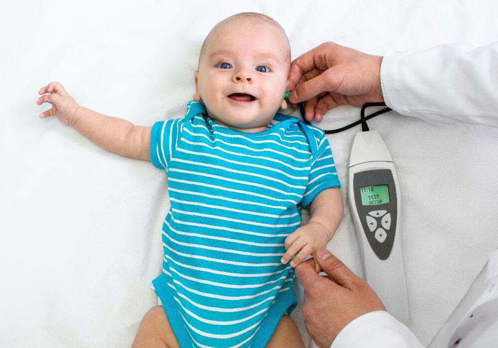 A new born smiling during hearing screening